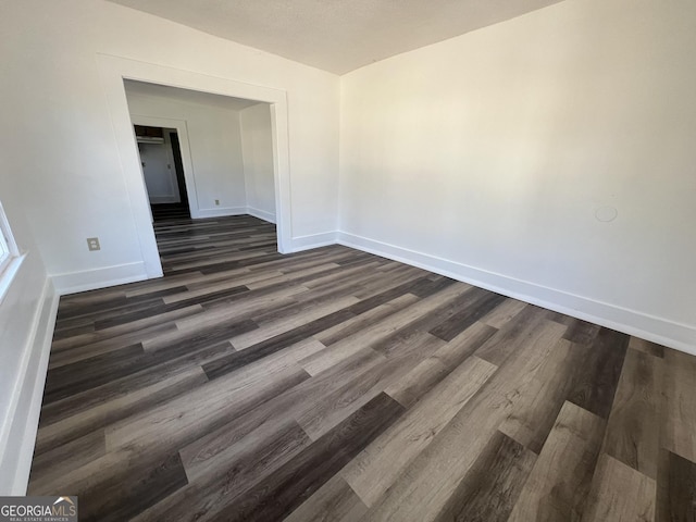 unfurnished room featuring dark hardwood / wood-style flooring