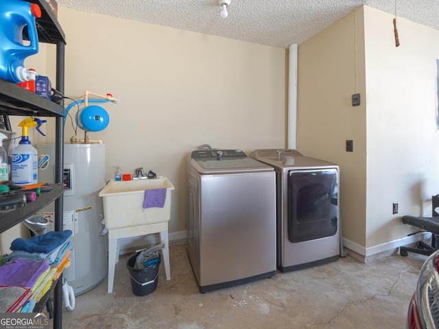 clothes washing area with water heater, a textured ceiling, and independent washer and dryer