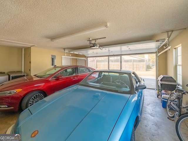 garage with a carport, a garage door opener, and electric panel