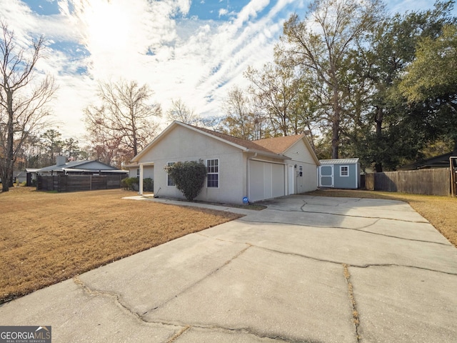 view of home's exterior with a yard and a storage unit