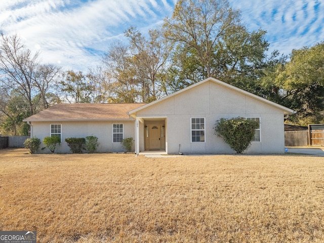 single story home featuring a front lawn