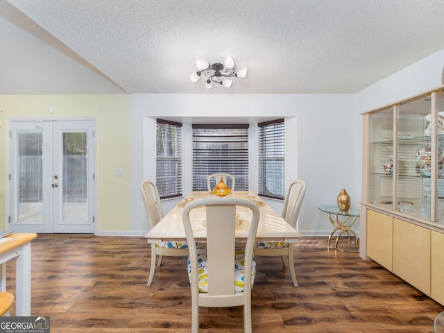 dining space featuring french doors, dark hardwood / wood-style flooring, and a textured ceiling