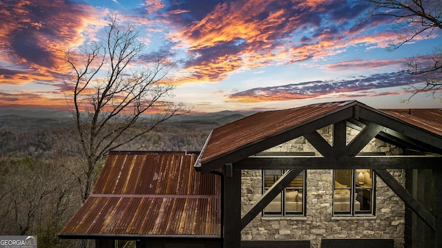 property exterior at dusk with a mountain view