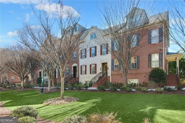 view of property featuring a front lawn