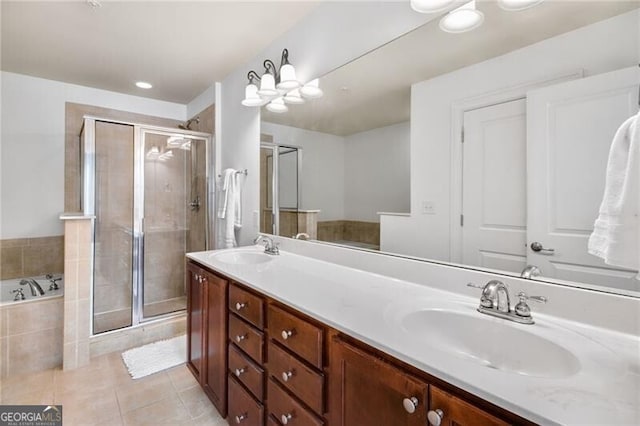 bathroom with vanity, tile patterned floors, and shower with separate bathtub