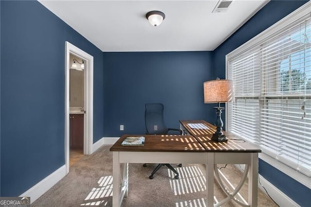 office space featuring light carpet and a wealth of natural light