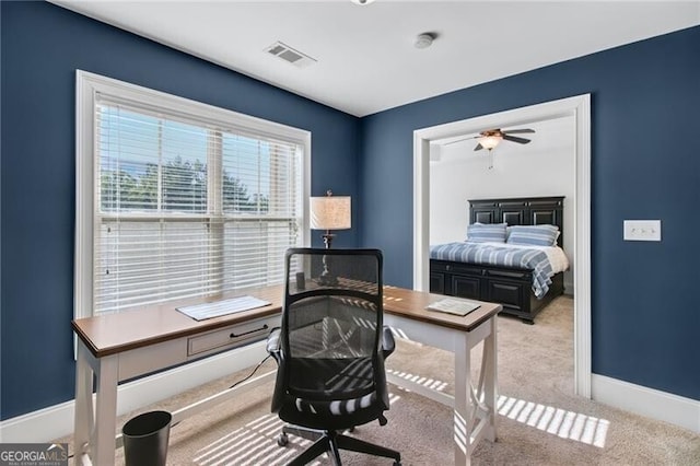 carpeted office featuring ceiling fan