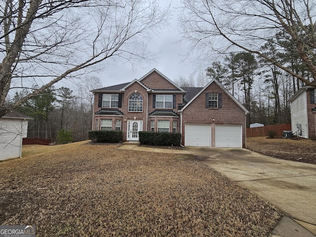 front of property with cooling unit and a garage