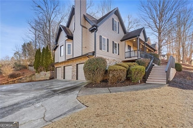 view of home's exterior featuring a garage and covered porch