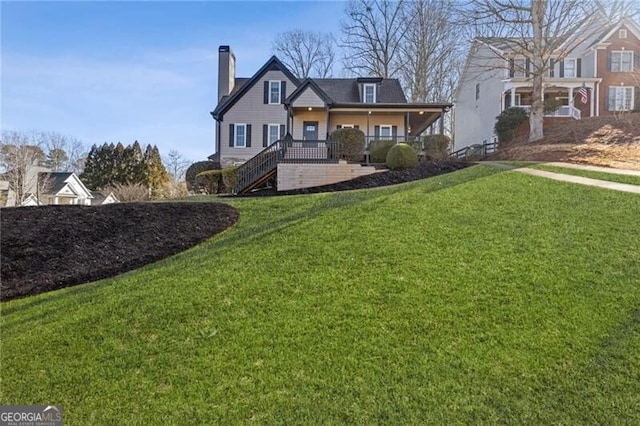 view of front facade with a front yard and covered porch