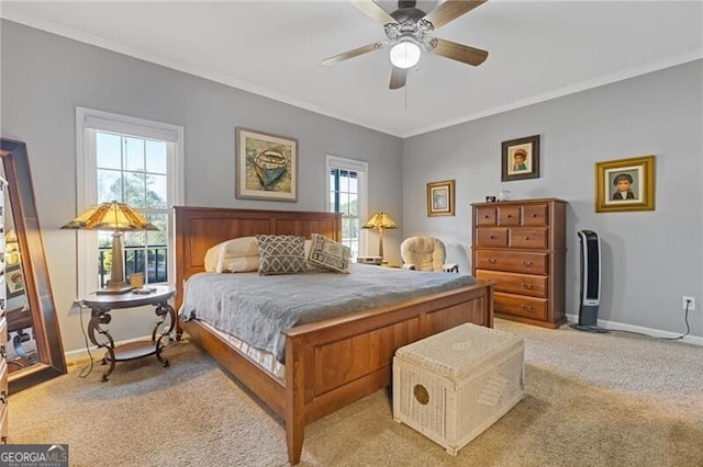 carpeted bedroom with ornamental molding and ceiling fan