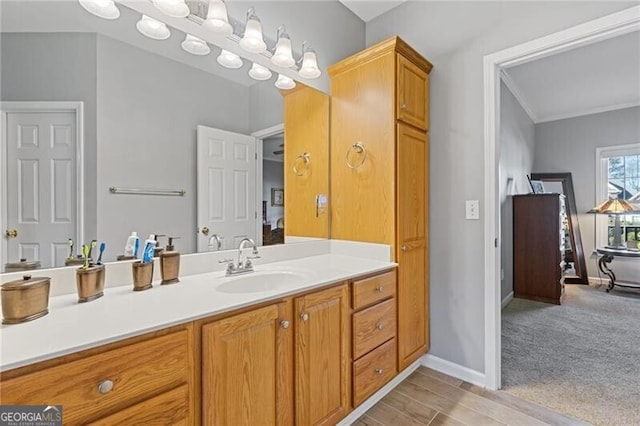 bathroom featuring crown molding and vanity