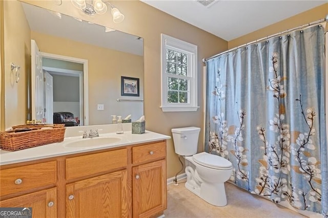 bathroom featuring vanity and toilet