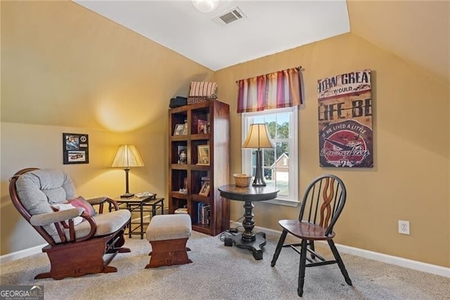 sitting room featuring lofted ceiling and carpet