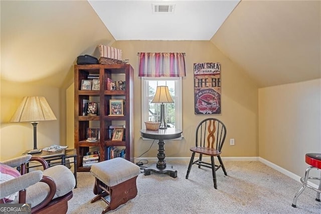 sitting room featuring light colored carpet and vaulted ceiling