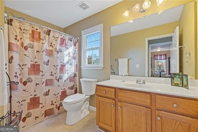 bathroom with vanity, curtained shower, and toilet