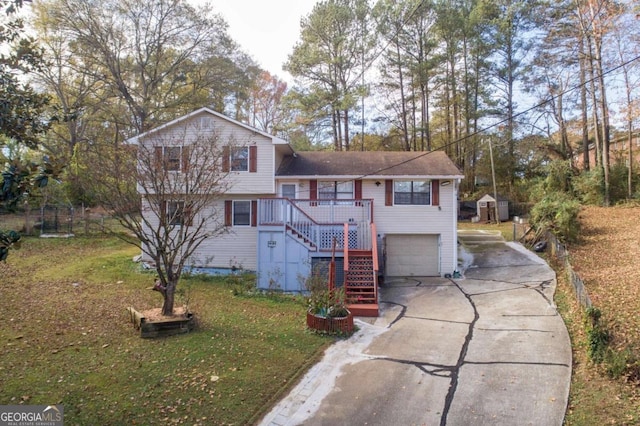 split level home featuring a garage and a front lawn