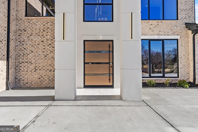 entrance to property featuring stucco siding