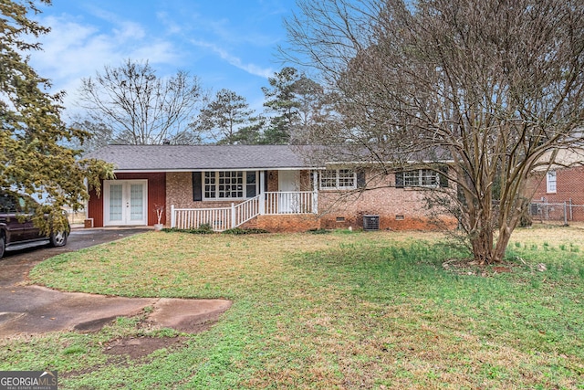 ranch-style home featuring french doors, a porch, a front lawn, and cooling unit