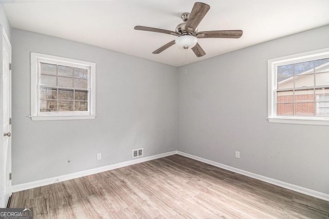 empty room featuring hardwood / wood-style flooring and ceiling fan