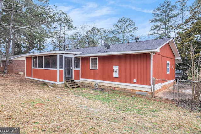 back of property with a sunroom