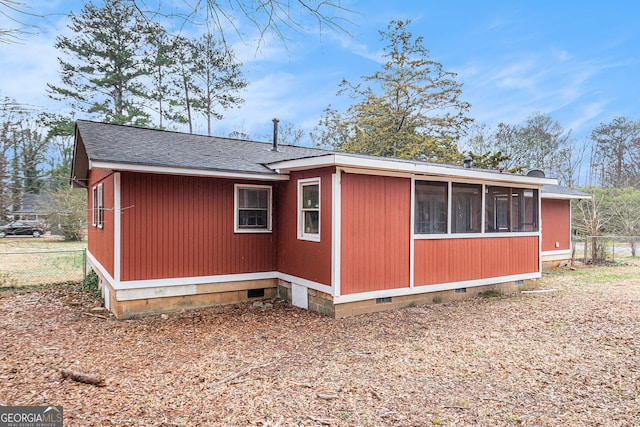 view of side of property with a sunroom