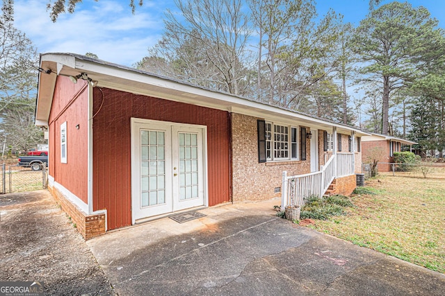 single story home with french doors and covered porch