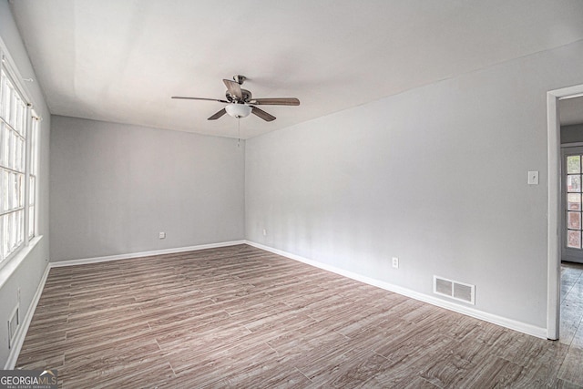 unfurnished room featuring hardwood / wood-style floors and ceiling fan