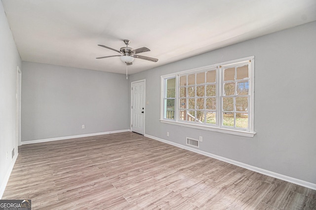 spare room featuring ceiling fan and light hardwood / wood-style flooring