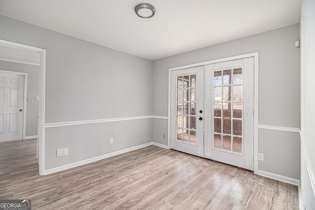 unfurnished room with light hardwood / wood-style flooring and french doors