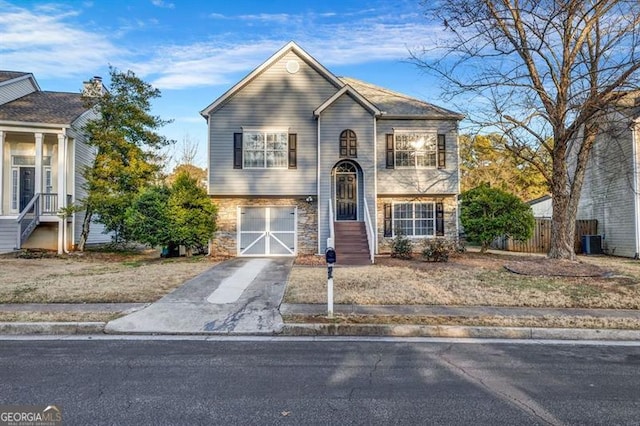 view of front of home featuring a garage and central AC unit