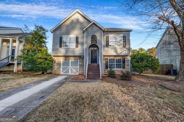 view of front of house with central AC and a garage