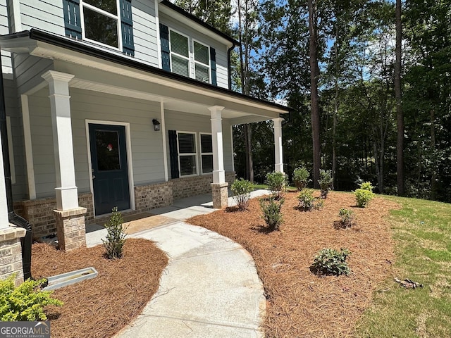 view of exterior entry with a porch