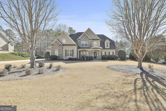 craftsman-style home featuring stone siding