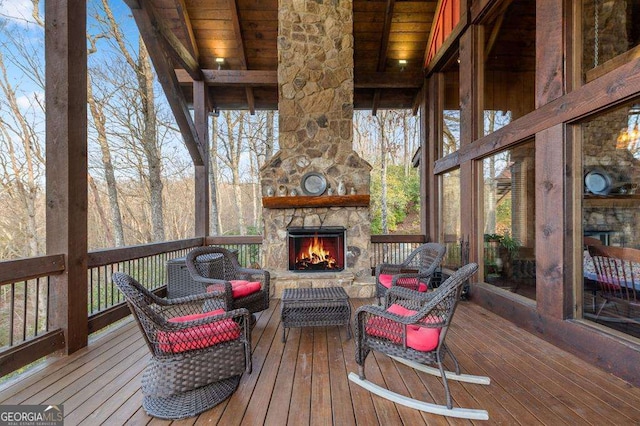 wooden deck featuring an outdoor living space with a fireplace