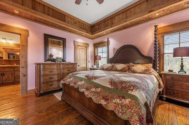 bedroom featuring multiple windows, dark wood-type flooring, and ceiling fan