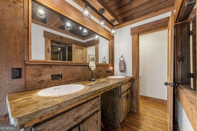 bathroom featuring beamed ceiling, wood-type flooring, vanity, and wooden ceiling