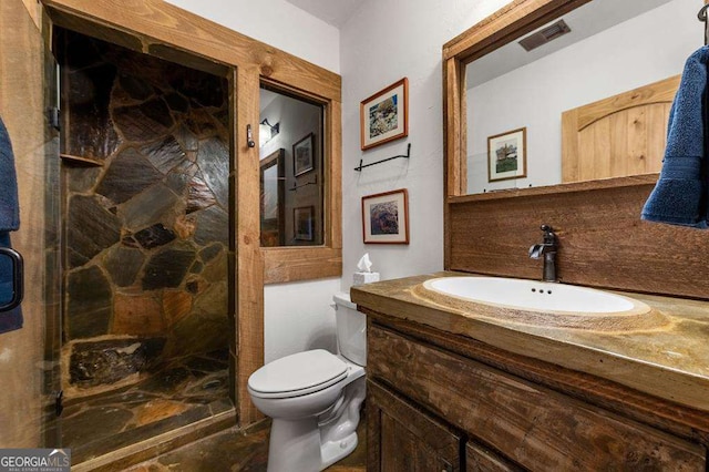 bathroom featuring tasteful backsplash, tiled shower, vanity, and toilet