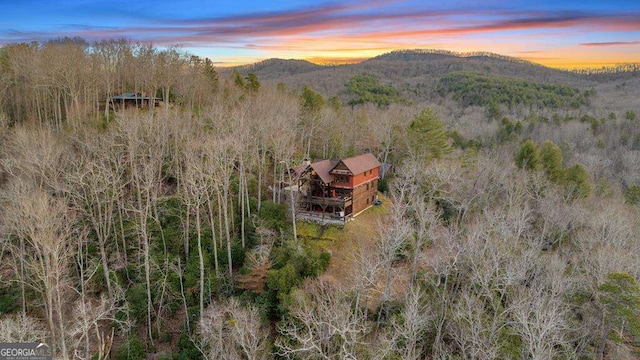 aerial view at dusk featuring a mountain view