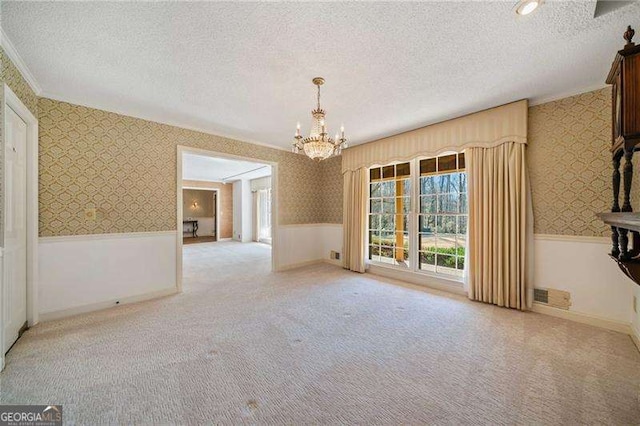 interior space with ornamental molding, a chandelier, and a textured ceiling