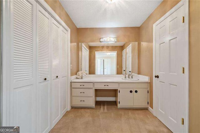 bathroom featuring vanity and a textured ceiling