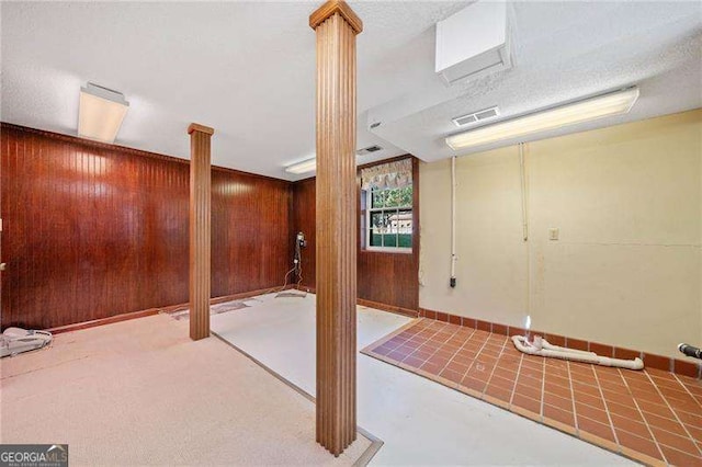 basement featuring wood walls