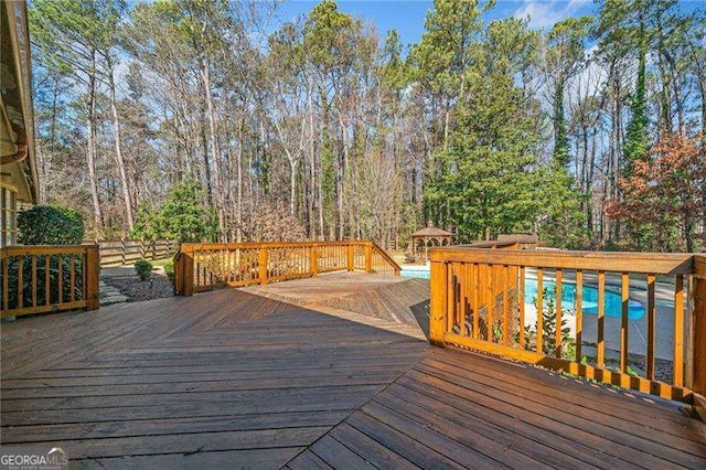 wooden terrace with a swimming pool