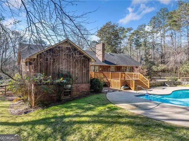 view of yard featuring a pool side deck and a patio area