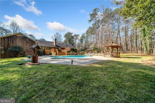 view of pool with a gazebo and a yard