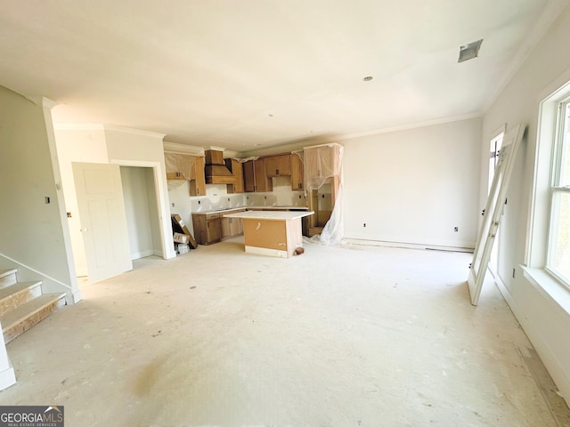 unfurnished living room with crown molding