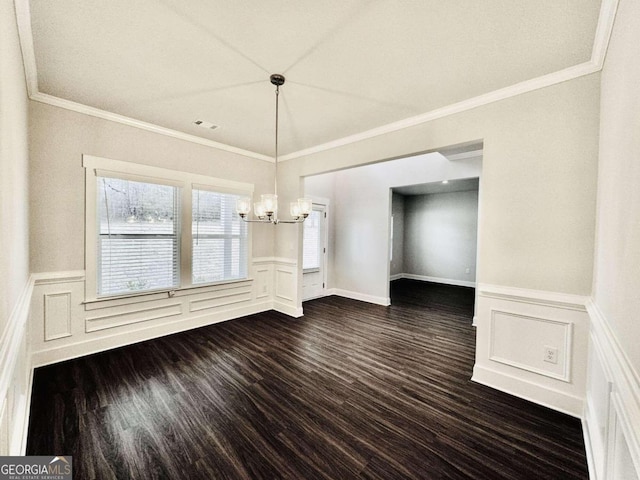 unfurnished dining area with ornamental molding, dark hardwood / wood-style floors, and a chandelier