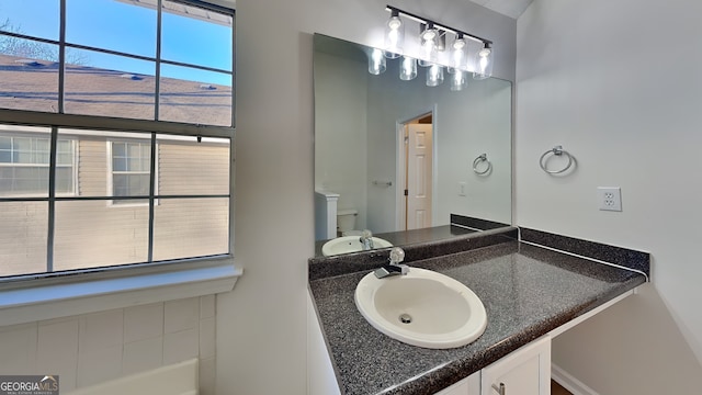 bathroom featuring vanity and toilet