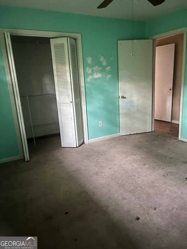 unfurnished bedroom featuring carpet and a closet