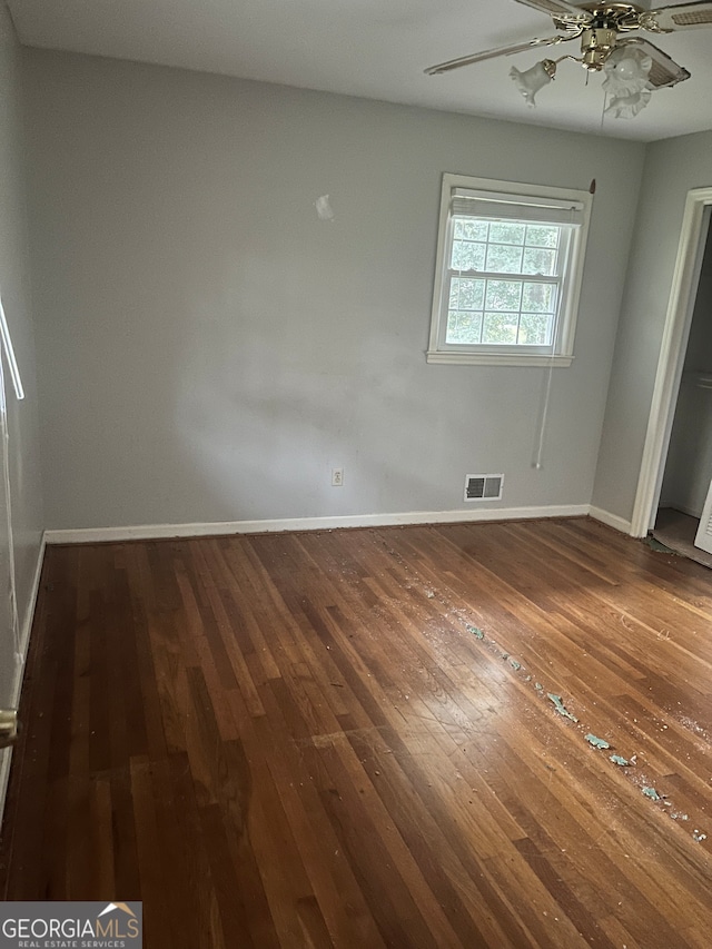 unfurnished bedroom with dark hardwood / wood-style floors and ceiling fan